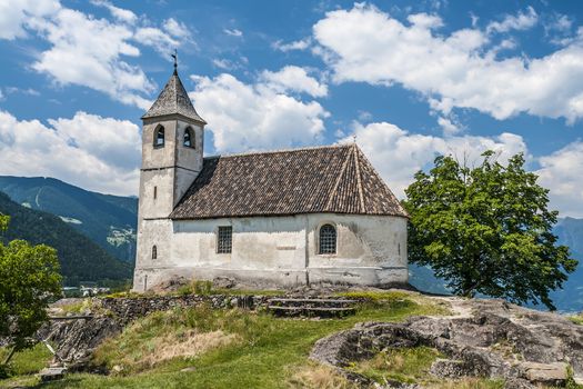 chapel in south tirol italy with tree, blue sky and white clouds