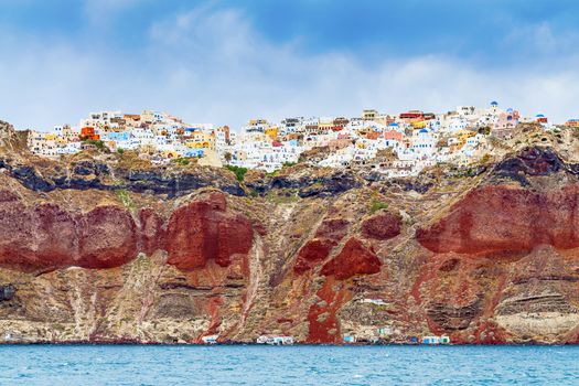 Look at the rocks with Oia on Santorini from the sea