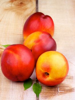 Heap of Perfect Ripe Peaches closeup on Wooden background