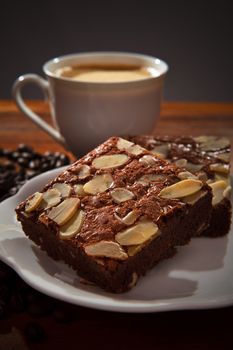 brownie cake and hot coffee on wood table