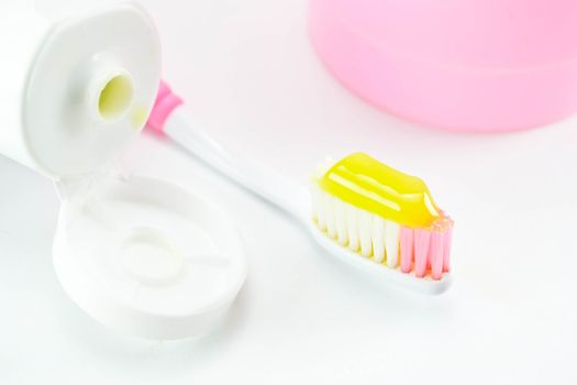 Toothbrush and toothpaste on white background