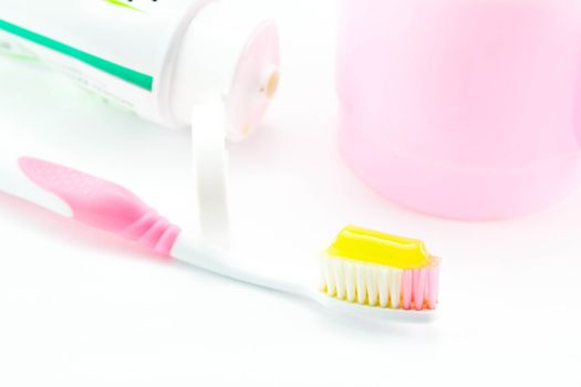 Toothbrush and toothpaste on white background