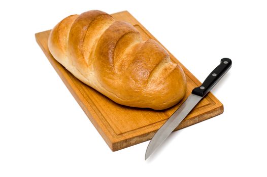 fresh natural bread with knife on breadboard