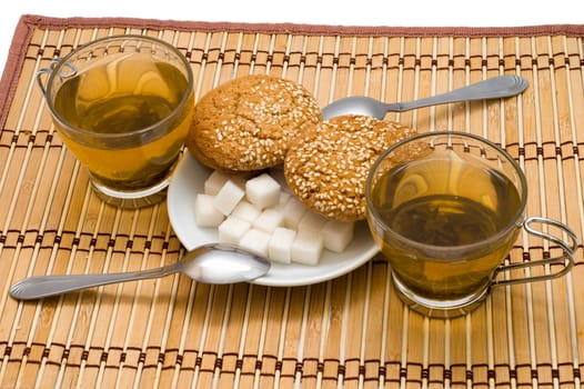 two cup with tea, sugar and cookies