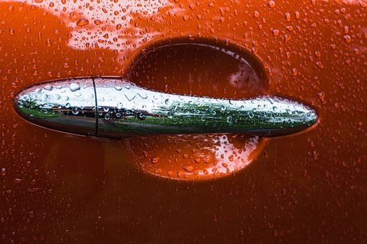 Handle orange car is wet from the rain