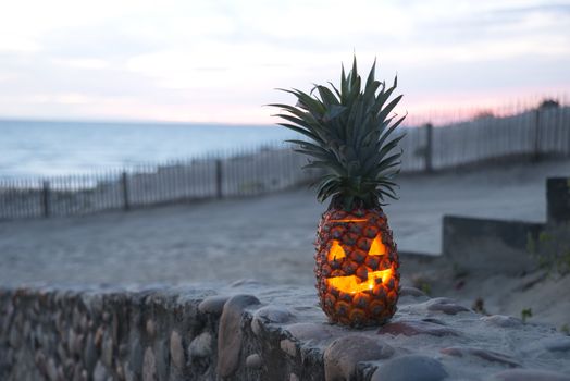 Tropical Halloween pineapple lantern on beach smiling