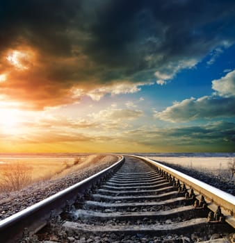 railway to horizon under dramatic sky