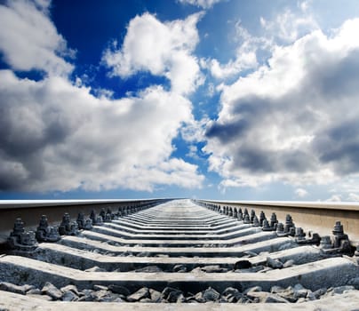 railway to horizon under cloudy sky