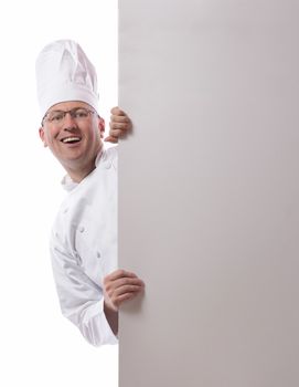 Male chef smiling from behind card isolated on white