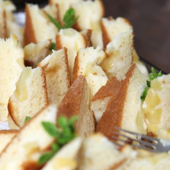 Delicious individual slices of apple cake on a buffet table arranged in the upright position at a wedding reception or catered event