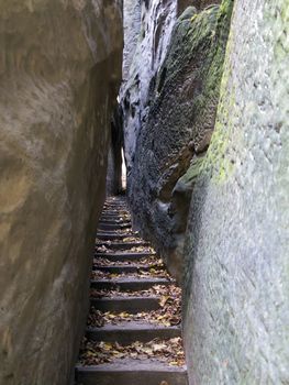 Narrow Parh - Mousehole - in rocks city in Bohemian Paradise.
Bohemian Paradise is the Natural Protected Area. It was declared in 1955 was the first nature reserve in the Czech Republic. This part of land is popular thanks to a beautiful and varied countryside. There are a lot of places which should be seen - many natural beauties, castles, chateaus, ruins, museums, and other sights.