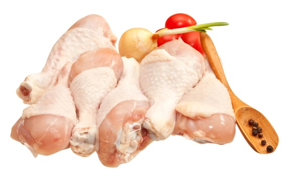 Raw chicken legs with vegetables, isolated on white background
