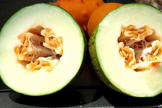 Exotic fruits: melon, kiwano and orange
