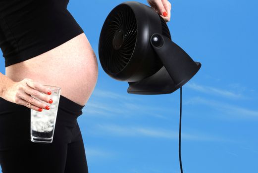 pregnancy hormones and hot flash with fan and glass of ice water