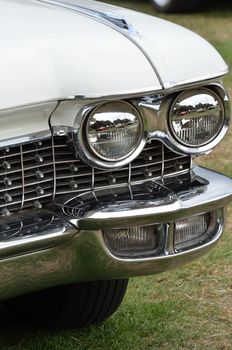 Classic car with radiator and headlights in portrait
