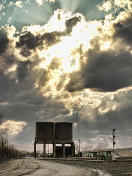 urban railyard with clouds and sunrays