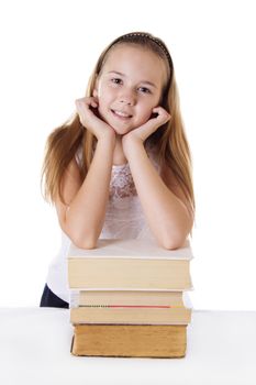 Cute schoolgirl on pile of books isolated on white