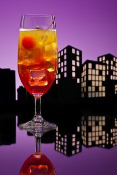 Metropolis Tequila Sunrise cocktail in city skyline setting