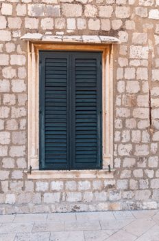 Framed ancient window with shutters in Dubrovnik