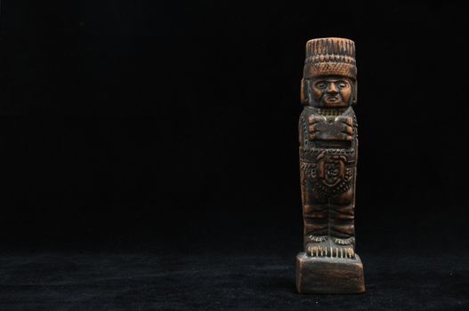 One Ancient Mayan Statue on a Black Background