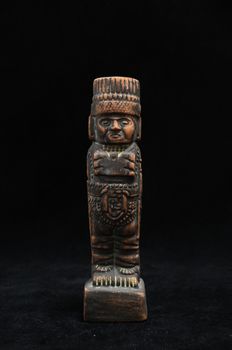 One Ancient Mayan Statue on a Black Background