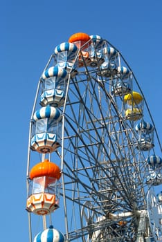 Colored Ferris wheel with blue sky background