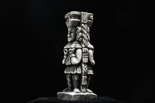 One Ancient Mayan Statue on a Black Background