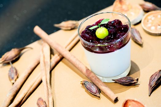 panna cotta with sauce of blackberries with ingredients background