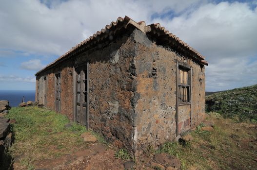 Brown Ancient Rural House on a Cloudy Sky