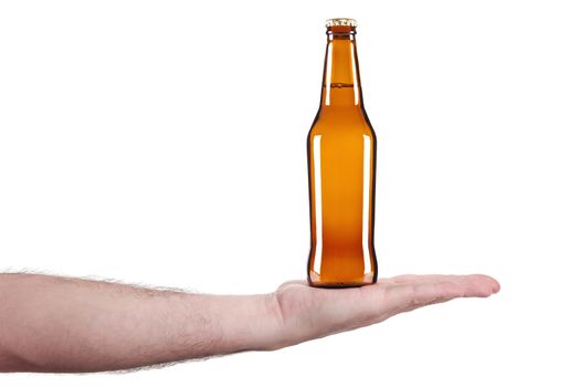 A bottle of beer in the palm of a hand.