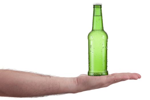 A bottle of beer in the palm of a hand.