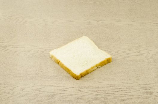 sliced bread on brown wood background