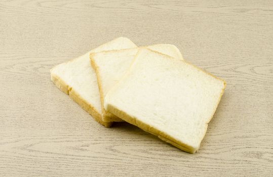 sliced bread on brown wood background