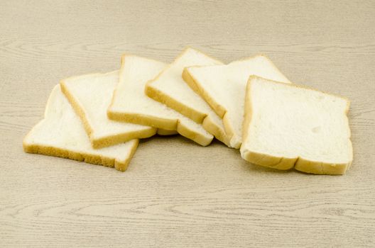 sliced bread on brown wood background