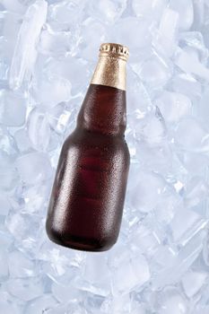 A bottle of dark beer on ice.