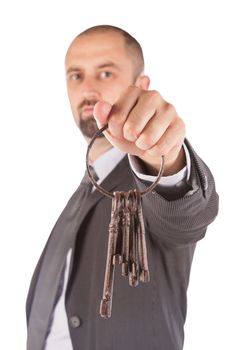 Man in suit giving old keys to a house, isolated on white