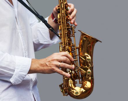 hands of a musician playing the saxophone