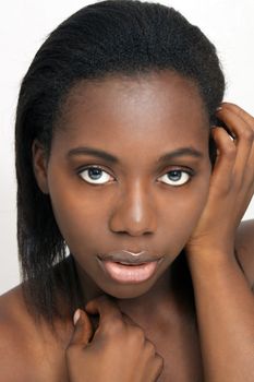 A close-up of a lovely young black woman with bare shoulders.