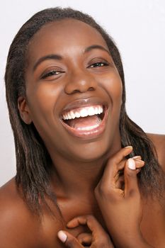 A close-up of a lovely young black woman with bare shoulders.