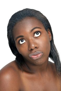 A close-up of a lovely young black woman with bare shoulders, looking up with a perplexed facial expression.