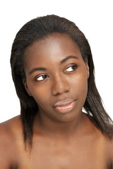 A close-up of a lovely young black woman with bare shoulders, looking toward frame right with a sly facial expression.