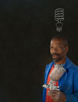 African or American black man industrial worker with chalk energy saving lightbulb on blackboard background