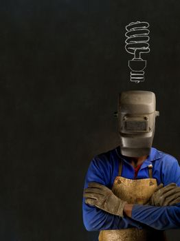 African or American black man industrial worker with chalk energy saving lightbulb on blackboard background