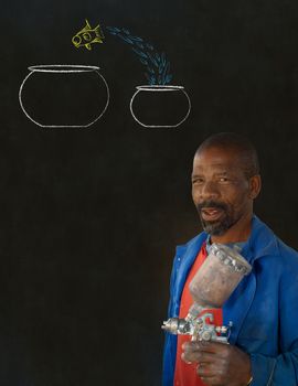 African American black man industrial worker with chalk jumping fish bowls on a blackboard background