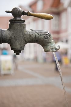 old fashioned metal  tap running