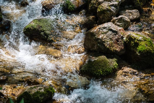 Detail of beautiful waterfall in summer sunlight in the Bavarian Alps