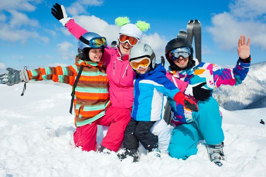 Skiing, winter, snow, sun and fun - family enjoying winter vacations