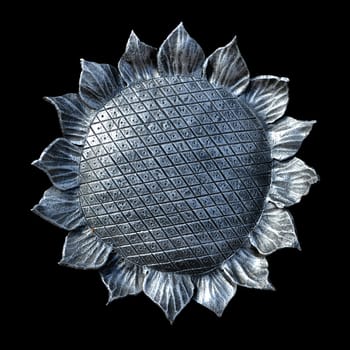 The isolate metal forged sunflower on a black background