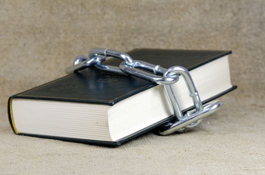 book surrounded with chain
