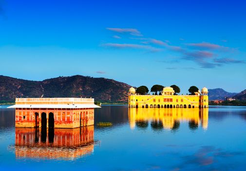 The palace Jal Mahal at sunset.  Jal Mahal (Water Palace) was built during the 18th century in the middle of Mansarovar Lake.  Jaipur, Rajasthan, India, Asia. Panorama.